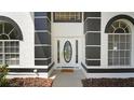 Close-up of the front entry featuring an oval glass door and black accent pillars at 2233 Blossomwood Dr, Oviedo, FL 32765