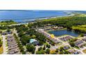 Overhead view of residential neighborhood with mature trees, community pool and scenic lake at 2340 Grasmere View S Pkwy, Kissimmee, FL 34746