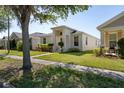 Well-manicured lawn and landscaped garden compliment this modern single-story home at 2340 Grasmere View S Pkwy, Kissimmee, FL 34746