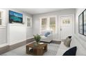 Bright living room featuring a cozy seating area with natural light, modern decor, and hardwood floors at 2504 Yale Ave, Sanford, FL 32773