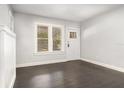 Bright living room with dark hardwood floors, fresh gray paint, and natural light from large windows at 2504 Yale Ave, Sanford, FL 32773