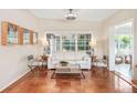 Bright living room featuring hardwood floors, large windows, and modern furniture at 2707 Chelsea St, Orlando, FL 32803