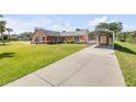 Well-maintained home with a long driveway and covered parking area at 2945 Juniper Dr, Edgewater, FL 32141