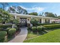 Inviting front entrance with decorative pillars, manicured shrubs, and a welcoming walkway at 3015 Dawley Ave, Orlando, FL 32806