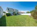 Expansive backyard with lush green grass and a white fence for privacy at 3312 Cordgrass Pl, St Cloud, FL 34773