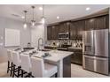 Modern kitchen featuring a large island, stainless steel appliances, and pendant lighting at 3529 Yarian Dr, Haines City, FL 33844