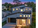 Exterior view of a two-story home at dusk, showcasing modern architecture and design at 3608 Dubsdread Cir, Orlando, FL 32804