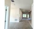 Bright, open-concept living room featuring plush carpet, and recessed lighting at 4278 Sagefield Dr, St Cloud, FL 34773
