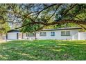 Beautiful single-story home with a well-manicured lawn and mature trees offering curb appeal at 505 Lake Shore Dr, Maitland, FL 32751