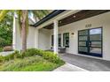 Close up view of the front entrance with modern design, black door and side lights at 532 Worthington Dr, Winter Park, FL 32789