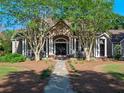 Inviting front entrance with a stone pathway and covered porch with rocking chairs at 6037 Lake Erie Rd, Groveland, FL 34736