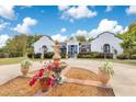 Elegant home exterior with a fountain centerpiece, showcasing beautiful landscaping and a welcoming entrance at 6816 Greengrove Blvd, Clermont, FL 34714