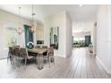 Bright dining room featuring a modern table, stylish light fixtures, and an open floor plan at 7928 Jacks Club Dr, Kissimmee, FL 34747