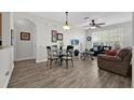 Open concept living and dining room with wood floors and lots of natural light at 8107 Coconut Palm Way # 102, Kissimmee, FL 34747