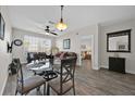 Living room featuring wood floors, ceiling fan and access to the main bedroom at 8107 Coconut Palm Way # 102, Kissimmee, FL 34747