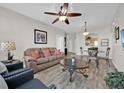 Living room and dining room area with wood floors and neutral color palette at 8107 Coconut Palm Way # 102, Kissimmee, FL 34747