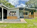 Charming single-story home featuring a covered carport and front porch, enhanced by a well-manicured lawn at 844 Rosalia Dr, Sanford, FL 32771