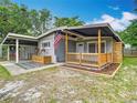 Lovely home boasts a quaint porch and convenient covered parking at 844 Rosalia Dr, Sanford, FL 32771