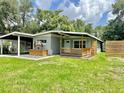 Charming single-story home featuring a covered carport and front porch, enhanced by a well-manicured lawn at 844 Rosalia Dr, Sanford, FL 32771