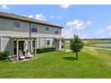 Spacious backyard with well-maintained lawn and pergola-covered seating area at 8549 Zoeller Hills Dr, Davenport, FL 33896