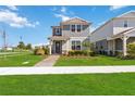 Charming two-story home featuring a quaint front porch and well-manicured lawn in a sidewalk neighborhood at 10209 Folly Beach Rd, Orlando, FL 32827