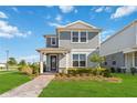 Charming two-story home featuring a quaint front porch and well-manicured lawn under a bright sky at 10209 Folly Beach Rd, Orlando, FL 32827