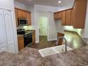 This spacious kitchen features stainless steel appliances and wood cabinets at 110 Sophia Marie Cv, Sanford, FL 32771