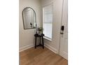 Entryway featuring a mirror, side table, and window, creating an inviting and well-lit space at 12850 Lexington Summit St, Orlando, FL 32828
