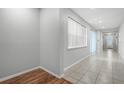 Bright hallway features tile floors and natural light streaming through the large window, leading to the front door at 14722 Porter Rd, Winter Garden, FL 34787