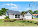 Charming single-story home featuring a gray exterior, well-maintained landscaping, and a brick-paved driveway leading to a two-car garage at 150 Dempsey Way, Orlando, FL 32835