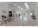 Spacious living room with tile flooring, large windows, and a bright and airy atmosphere with skylights at 150 Dempsey Way, Orlando, FL 32835