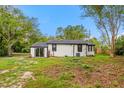 Exterior side view of the home with sliding glass door and spacious backyard at 151 Naranja Rd, Debary, FL 32713