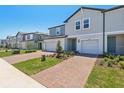 Lovely townhome with a one-car garage, brick driveway and well-kept landscaping at 16403 Bird Of Paradise Ave, Clermont, FL 34714
