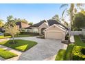 Stunning home featuring a paver driveway, mature landscaping, and a welcoming facade at 189 Hammock Oak Cir, Debary, FL 32713