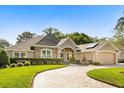 Lovely home with stone accents, inviting entrance, and a well-designed driveway at 189 Hammock Oak Cir, Debary, FL 32713