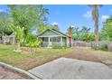 Bungalow-style home featuring a screened porch, driveway, and established landscaping at 2011 Harmon Ave, Winter Park, FL 32789