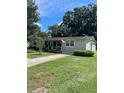 Well-maintained single-story house features a green lawn, and a walkway leading to the charming front entrance at 275 Virginia Dr, Winter Garden, FL 34787