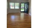 Inviting living room featuring hardwood floors, a bright window, and a stylish front door with glass panels at 275 Virginia Dr, Winter Garden, FL 34787