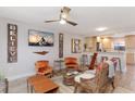 Bright living room with modern ceiling fan, stylish decor, and seamless flow to the kitchen area at 3254 Oak Lake Pl # 137, Winter Park, FL 32792