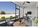 Relaxing screened patio with outdoor seating, a ceiling fan, and views of the fenced backyard at 3532 Yarian Dr, Haines City, FL 33844