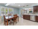 Inviting eat-in kitchen with tile floors, stainless steel appliances, and natural light at 3823 Martin St, Orlando, FL 32806