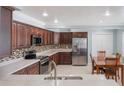Bright and open kitchen featuring stainless steel appliances, wood cabinets and a cozy dining area at 3823 Martin St, Orlando, FL 32806