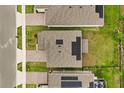 Aerial view of rooftops showing solar panels and green lawns between houses and brick paver driveways at 4216 Jespersen St, Apopka, FL 32712