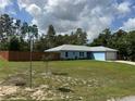 A blue single-story home with a fenced yard, well-kept lawn, and street corner location at 4382 Sw 171St Pl, Ocala, FL 34473