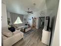 Cozy living room featuring comfortable seating, neutral tones, ceiling fan and modern flooring at 4382 Sw 171St Pl, Ocala, FL 34473