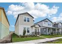 Modern two-story home showcasing light siding and a well-maintained front lawn at 4545 Cross Prairie Pkwy, St Cloud, FL 34772