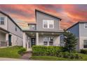 Charming two-story home features a modern design, landscaped yard and welcoming front porch at 4875 Lacewing Dr, Winter Garden, FL 34787