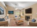 Inviting living room with plush seating, a stone fireplace, and natural light from large windows at 600 Fallsmead Cir, Longwood, FL 32750