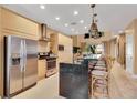 Well-equipped kitchen featuring stainless steel appliances and a central island with bar stools at 7645 Recife Dr, Kissimmee, FL 34747