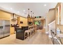 Modern kitchen with stainless steel appliances, a large island, and barstool seating at 7645 Recife Dr, Kissimmee, FL 34747
